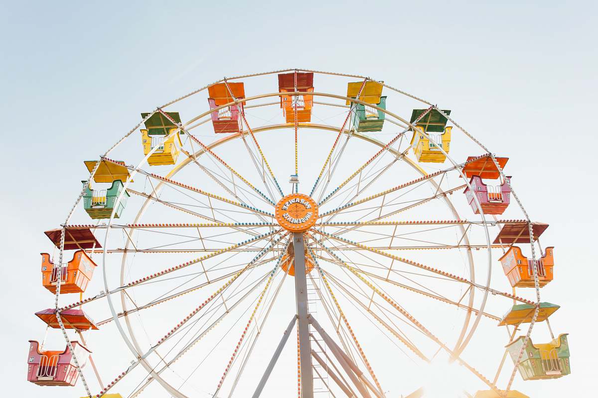 ferris wheel worm's eye view of red, orange, and yellow Ferris wheel amusement park